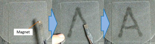 Handwriting with a magnet is demonstrated on a prototype of the new e-paper