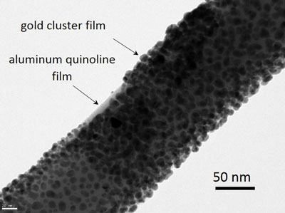 Transmission electron microscope (HRTEM) image of a GaAs-AlGaAs core-shell nanowire coated with nominally 10 nm aluminum quinoline and a 5 to 10 nm thick gold cluster film on top