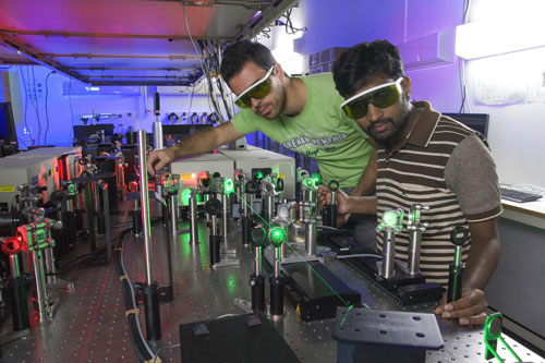 Athanasios Margiolakis and Bala Murali Krishna Mariserla, OIST Posdoctoral researcher, perform an experiment in Femtosecond laser laboratory