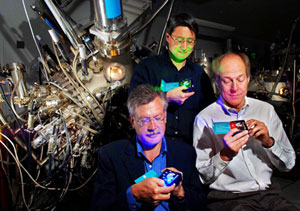 MSandia researchers Jerry Simmons (far left), Michael Coltrin, and Jeff Tsao (standing behind) check out solid-state lighting technologies