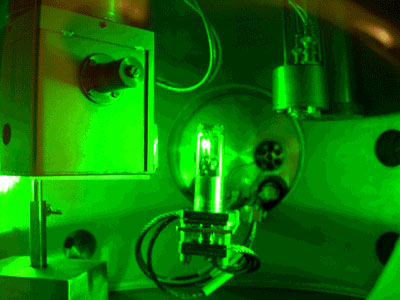 The photograph shows an experiment in which dense deuterium is irradiated by a laser. The white glow in the container in the centre of the photograph is from deuterium