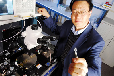 >Regents' professor Zhong Lin Wang with equipment used to measure output from his nanogenerators.
