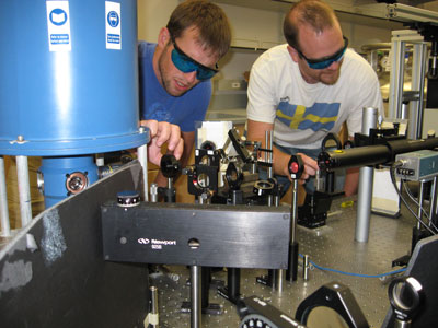 Alex High and Aaron Hammack adjust the optics in their UCSD lab.
