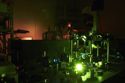 A prototype microscope system. Kenji Okamoto of the Cellular Informatics Laboratory demonstrates the experiment to test the performance of a prototype detector attached to a high-end optical microscope