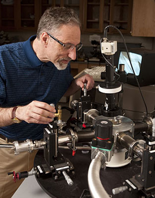 In his Johns Hopkins materials science lab, Howard E. Katz adjusts probes used for testing electronic devices