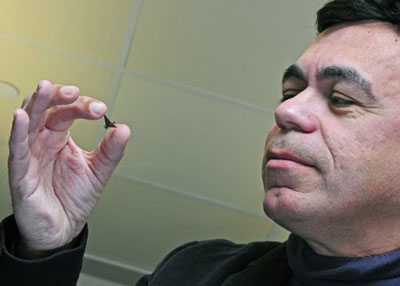 Babak Ziaie, a professor of electrical and computer engineering and biomedical engineering, holds a miniature birdlike shape made from ferropaper