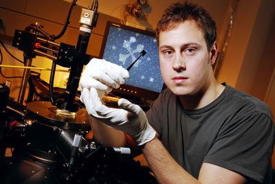 Graduate student Kevin Brenner holds a fabricated graphene sample