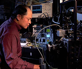 NIST physicist Sae Woo Nam works with refrigeration equipment used to cool photon detectors to nearly absolute zero. His team’s efforts have created devices that can detect single photons with 99 percent efficiency
