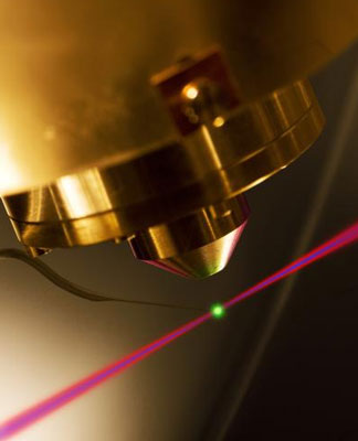 The photoemission of electrons by an attosecond light pulse (blue beam) is time resolved by controlling the electron motion with an ultrashort visible laser pulse (shown as red beam).