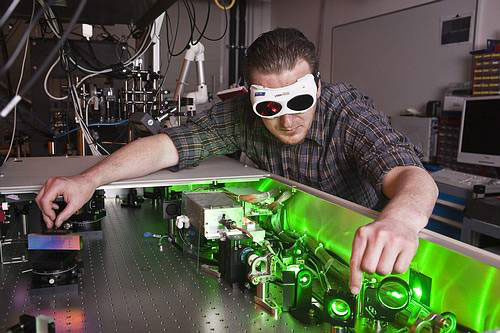 QUEST researcher adjusting a modern femtosecond laser system for the generation of nanostructures