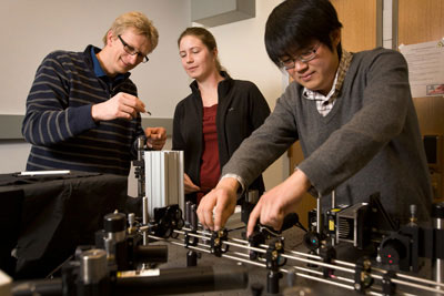 Ulrich Wiesner, left, works with graduate students Jennifer Drewes and Kai Ma to characterize the size and brightness of C dots