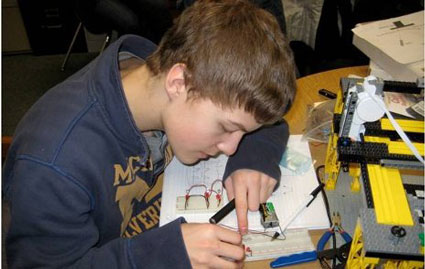 Chassell High School student Jared Jarvi working on the wiring of a 'bread board' for a light sensor array