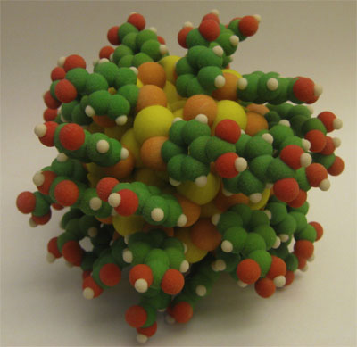 An atomistic model of the Au102(p-MBA)44 particle. Gold:yellow, sulfur:orange, carbon:green, oxygen:red, hydrogen:white