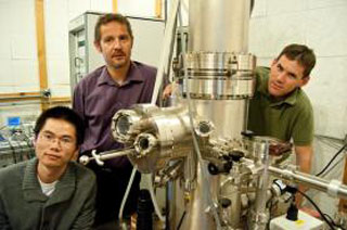 Jiamin Xue, Philippe Jacquod and Brian LeRoy (left to right) with the scanning tunneling microscope they use to study graphene
