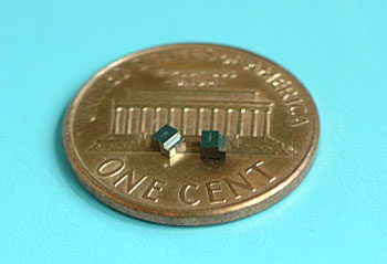 Two miniature magnetic switches on a US one-cent piece