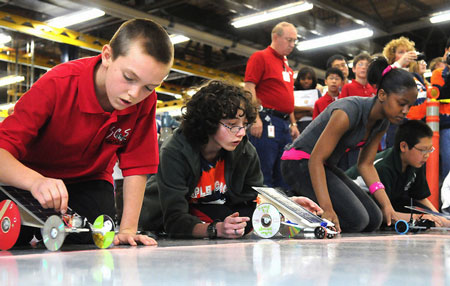 Middle school students from the Chicago area prepare to race their model solar/battery-powered cars