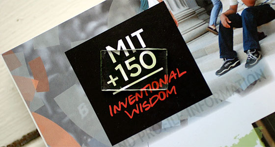 A prototype of the MIT researchers' transparent solar cell is seen on top of a promotional item for MIT's 150th anniversary celebrations