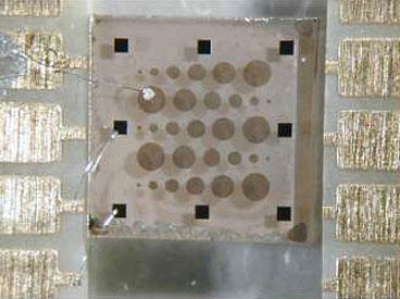  a sample of the lanthanum aluminate-strontium titanate composite, which looks like a slab of thick glass, with thin electrodes deposited on top of it