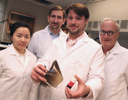Post-doctoral chemist Jaeton Glover (center) displays samples of polymers reinforced with graphene oxide