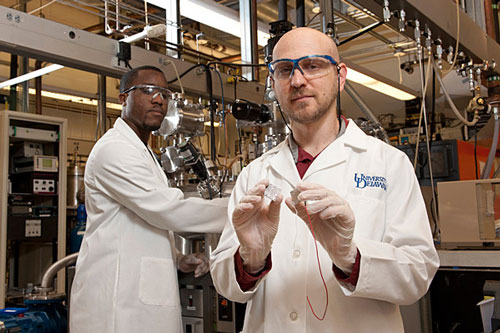 Joshua Zide (right), assistant professor of materials science and engineering, at work in the laboratory with Pernell Dongmo, a doctoral candidate in the College of Engineering.