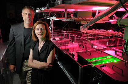 CU-Boulder physics professors and JILA fellows Henry Kapteyn and Margaret Murnane stand next to one of their laser devices