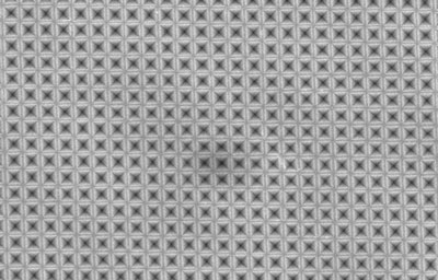 a sheet of silicon has been textured with an array of tiny inverted-pyramid shapes
