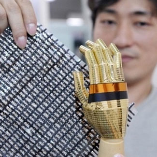 Tsuyoshi Sekitani displays an elastic sheet containing carbon nano tubes which conduct electricity