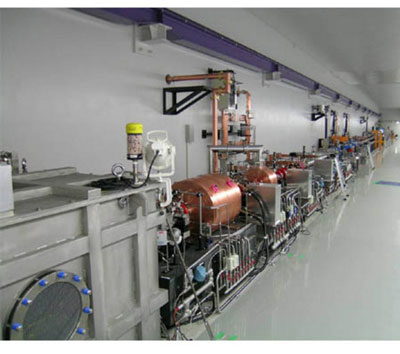 A view at the beam hall of the FEL test facility. The electron gun is contained in the grey box on the left