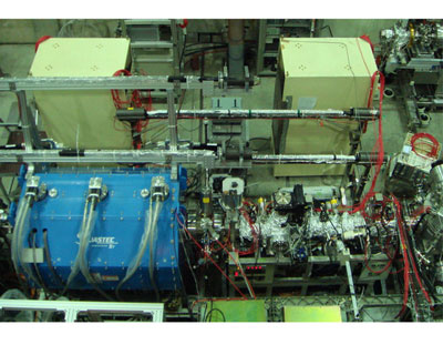 The superconducting solenoid (lower left in blue) contains the multi-ring trap for catching and cooling antiprotons and the beamline (lower right) transports ultra-slow antiproton beams to the collision chamber
