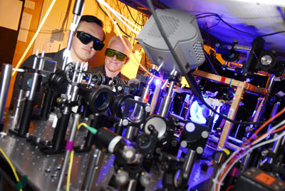 Associate professor Alex Kuzmich (left) and research scientist Stewart Jenkins, both of the Georgia Tech School of Physics, adjust optical equipment used to study quantum memory.