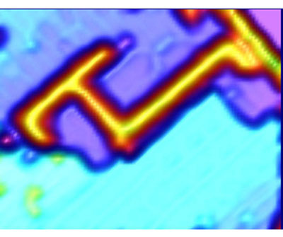 Scanning-tunneling microscopy image of acetophenone lines on a silicon surface. The lines of acetophenone can be seen as a bright orange line against the blue background of the surface.