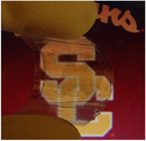 Transparent film holds embedded nanotube/nanowire capacitor with high energy density and storage capacity.