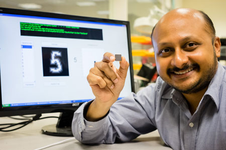 NTU Asst Prof Arindam Basu holding his low-powered smart chip