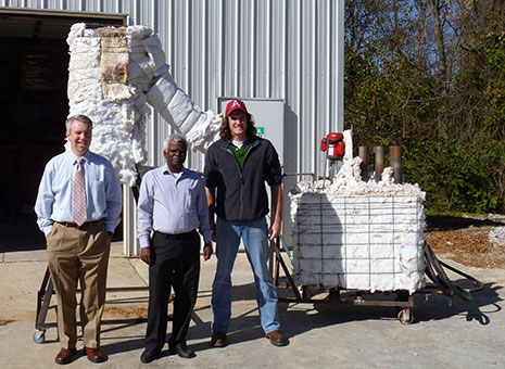Panneer Selvam, center, Micah Hale, left, and Matt Strasser display the thermocline energy storage test system