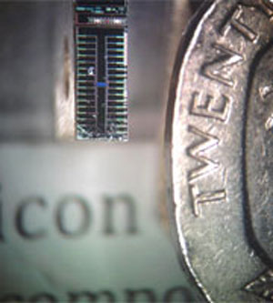 Example of a silicon quantum chip next to a 20 pence coin.