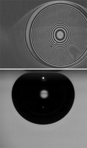 As an air bubble rising through water bumps against a glass plate (lower frame) it generates an interference pattern from a laser beam shining on the surface (upper frame).