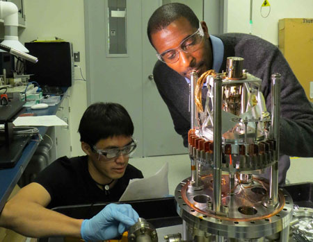 Postdoctoral researchers Marvin Cummings (at right) and Nozomi Shirato adjust the microscope before an experiment