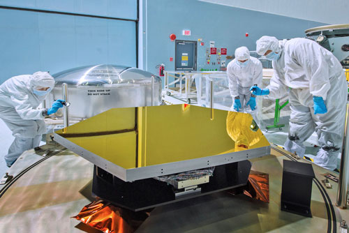 Technicians and scientists check out one of the Webb telescope's first two flight mirrors