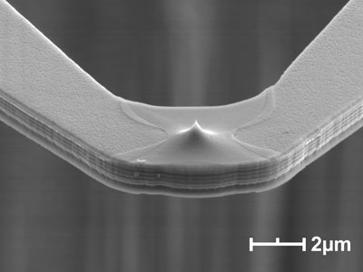 Scanning electron microscope images of a nanoheater cantilever with a sharp tip