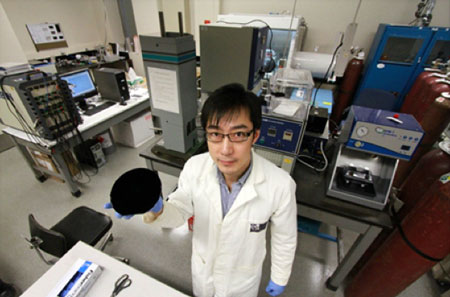 Xinwei Cui holds one of the nano-engineered carbon components of the new battery technology