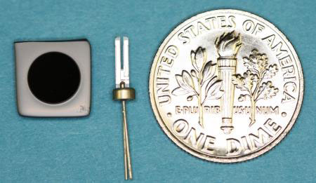 laser frequency reference, a small 6 mm disk next to a penny