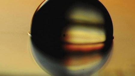 water droplet sitting on a ferrofluid-impregnated surface