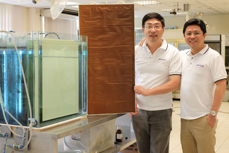 Assoc Prof Darren Sun (left) holding the new Nano Sun membranes, with Managing Director and NTU business professor Wong Ann Chai