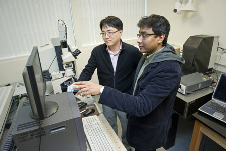 Swastik Kar (right), and Yung Joon Jung use a Raman Spectrometer to characterize the assembly of a carbon nanotube