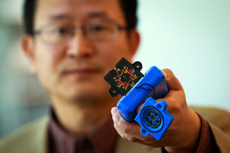 Ling Zang, a University of Utah professor of materials science and engineering, holds a prototype detector