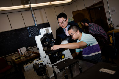 C.K. Choi, left, and PhD candidate Shuo Wang examine flow fields in a micro-channel