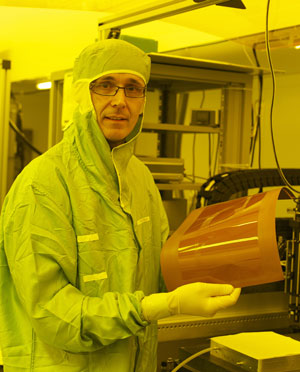 IBM scientist Roger Dangel holds a thin film polymer waveguide