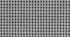 A scanning electron micrograph of an array of 50-nm-diameter magnetic islands