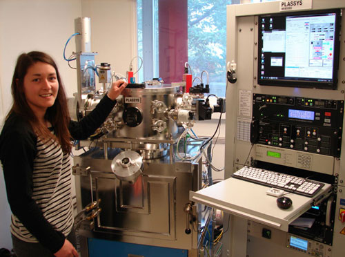 RHUL/NPL doctoral student Teresa Hoenigl-Decrinis next to the advanced thin-film deposition system