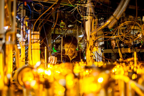 Graduate student Lawrence Cheuk adjusts the optics setup for laser cooling of sodium atoms